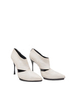 Pair of white high-heeled shoes on a white background