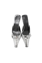 Pair of silver high-heeled shoes with embellishments on a white background