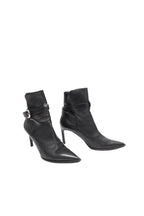 Pair of black high-heeled ankle boots on a white background