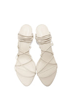 Pair of white strappy high-heeled shoes on a white background