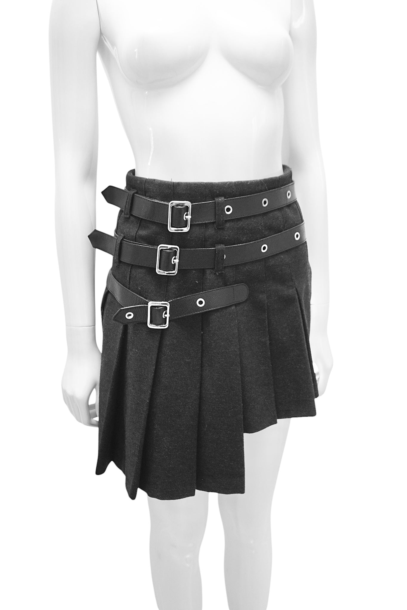 Black skirt with belt and buckles on a mannequin against a white background