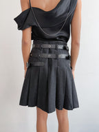 Person wearing a black outfit with a belt on a white background