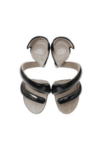 Pair of black and silver wing-shaped earrings on a white background