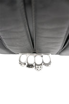 Silver knuckle duster on a gray fabric background