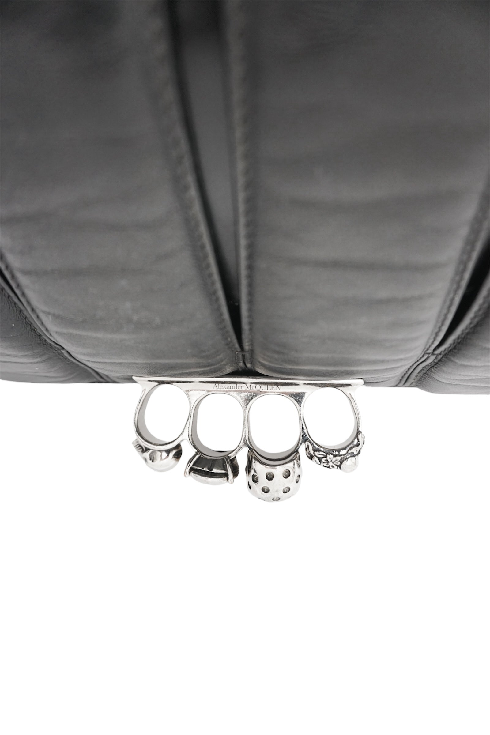 Silver knuckle duster on a gray fabric background