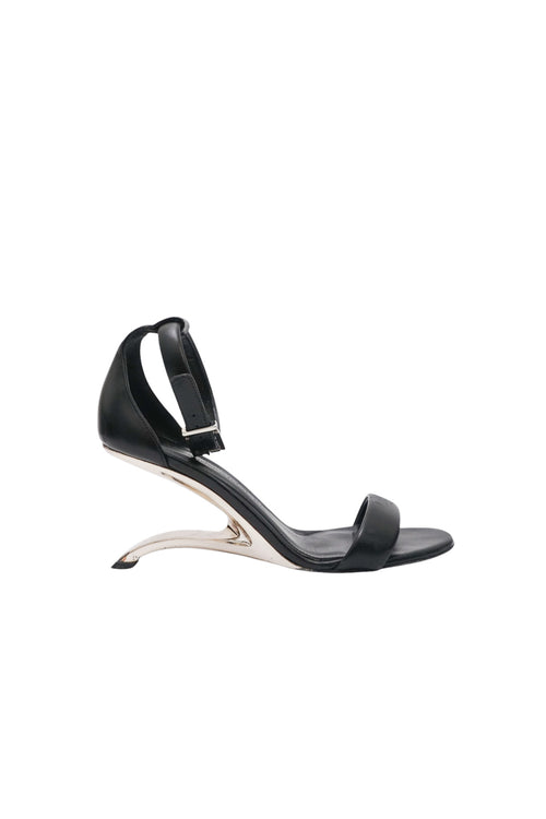 Black high-heeled sandal on a white background