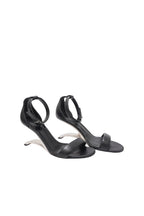 Black high-heeled sandals on a white background