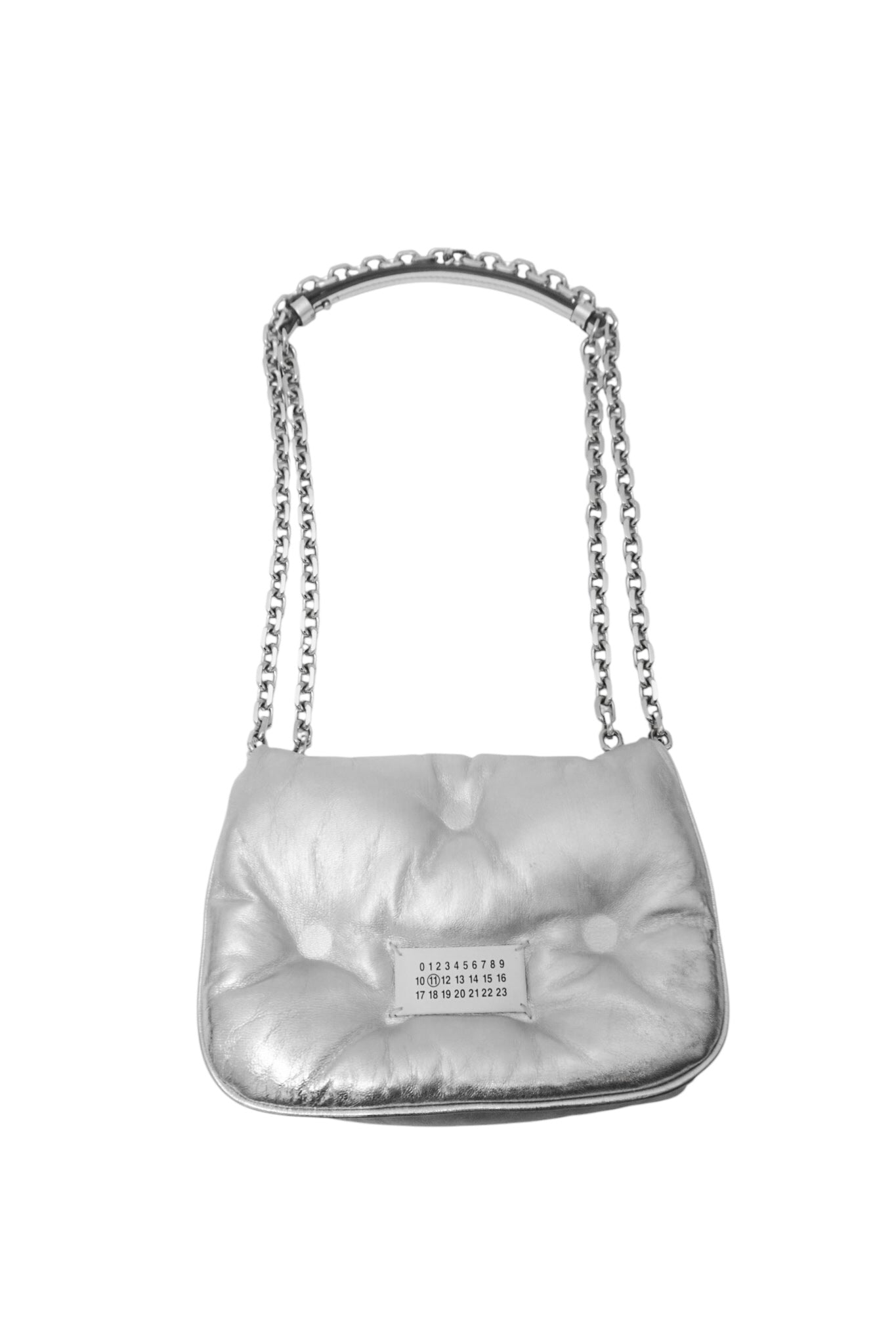 Silver quilted handbag with chain strap on a white background