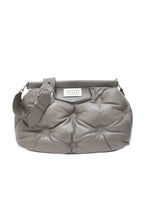 Gray quilted handbag on a white background