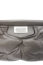 Gray quilted handbag with a visible brand label on a white background