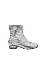 Black rain boot on a light gray background