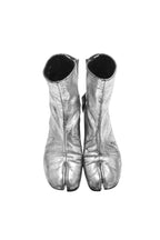 Pair of silver metallic tabi boots on a white background