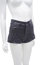 Mannequin wearing black leather shorts on a white background