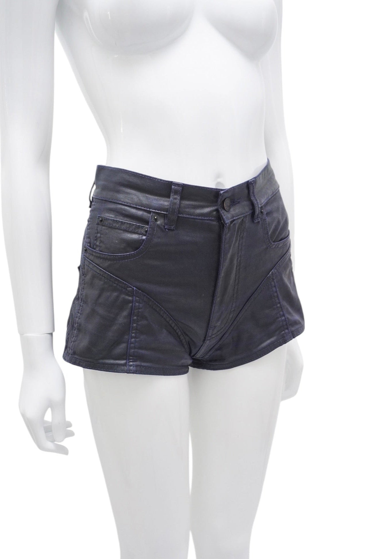 Mannequin wearing black leather shorts on a white background