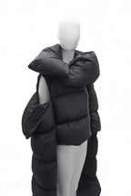 Black puffer coat on a mannequin against a white background