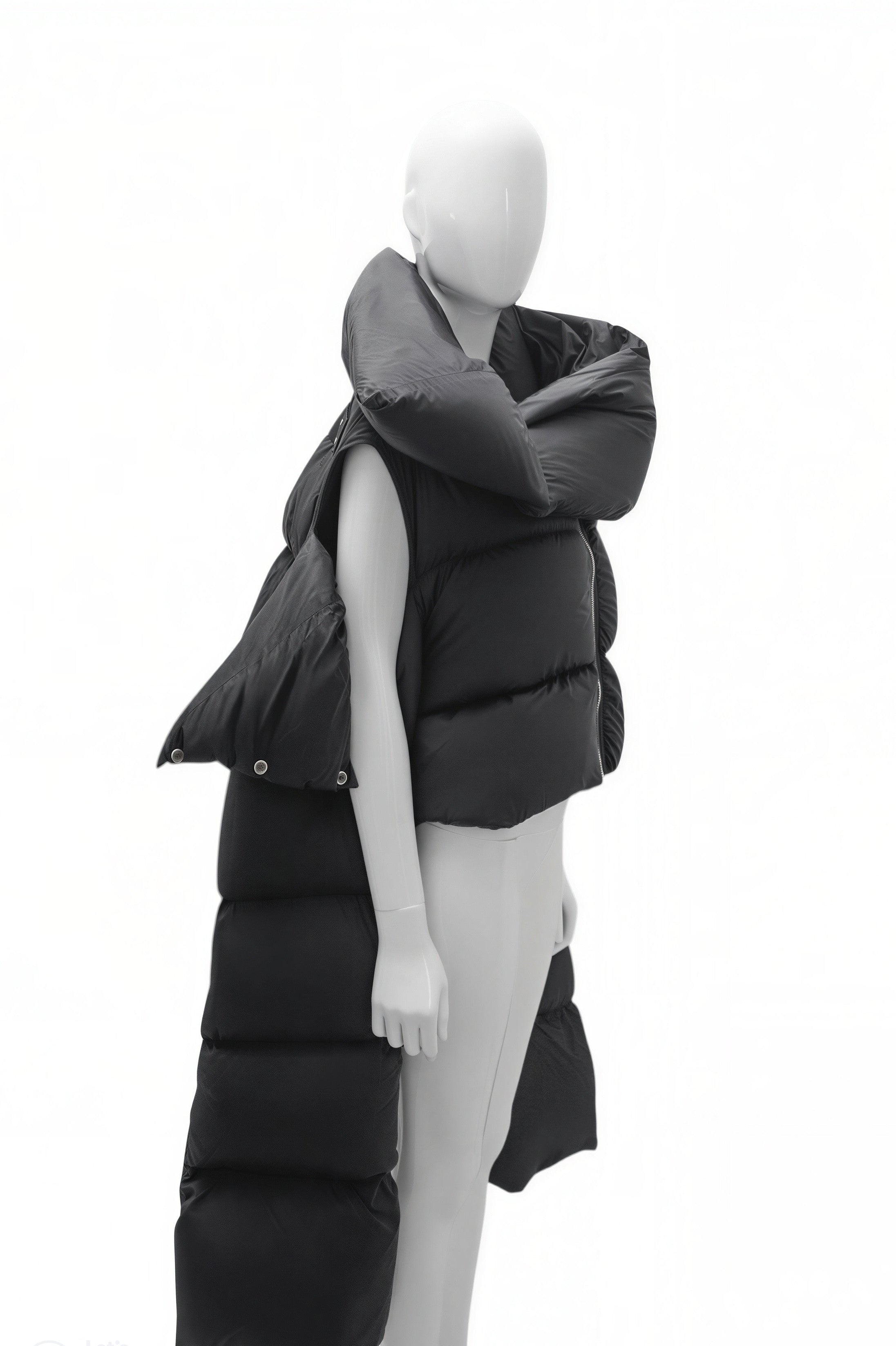 Mannequin wearing a long black puffer vest on a white background