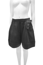 Black leather shorts on a white mannequin against a white background