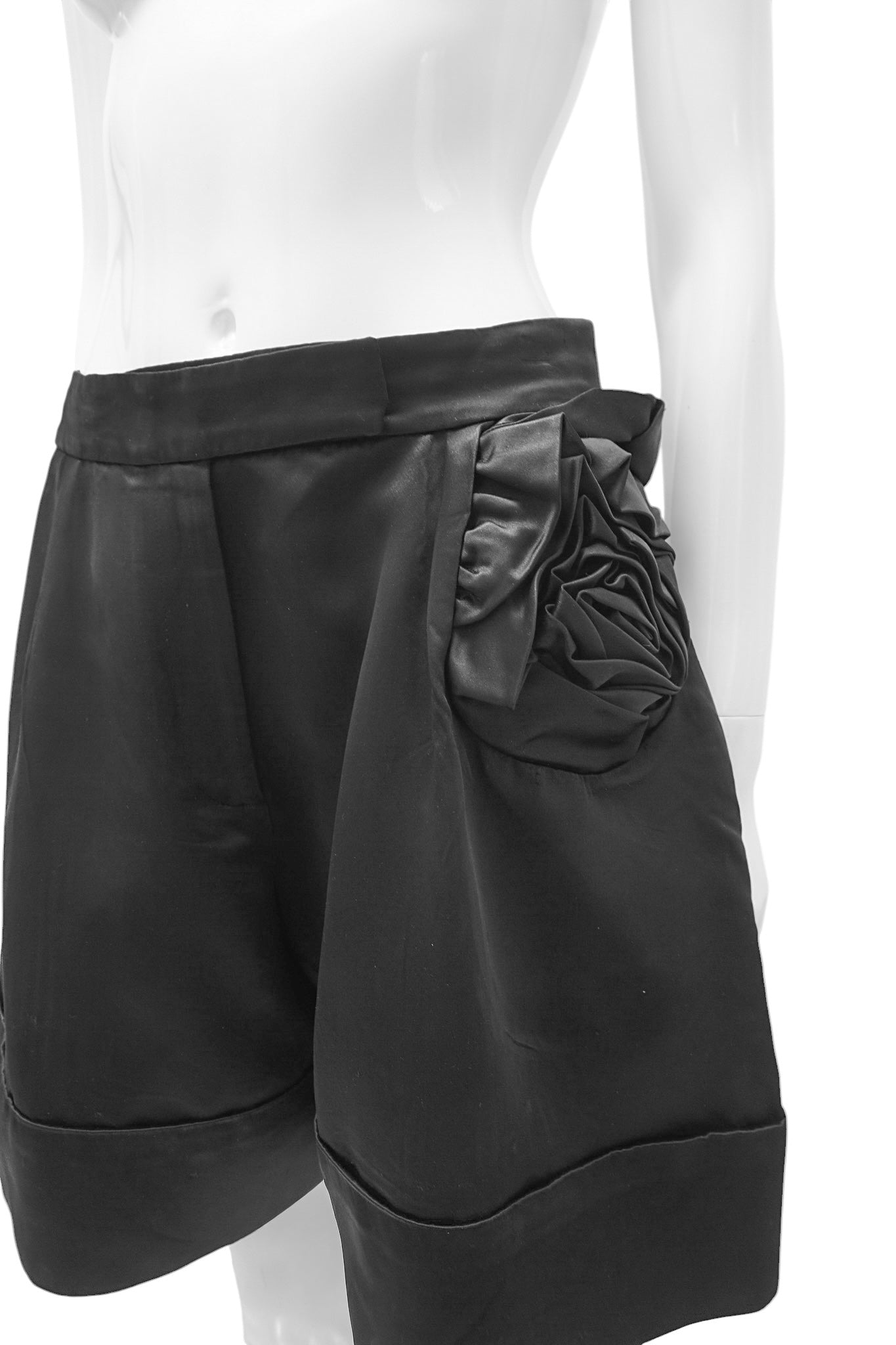 Black shorts with a floral detail on a mannequin against a white background