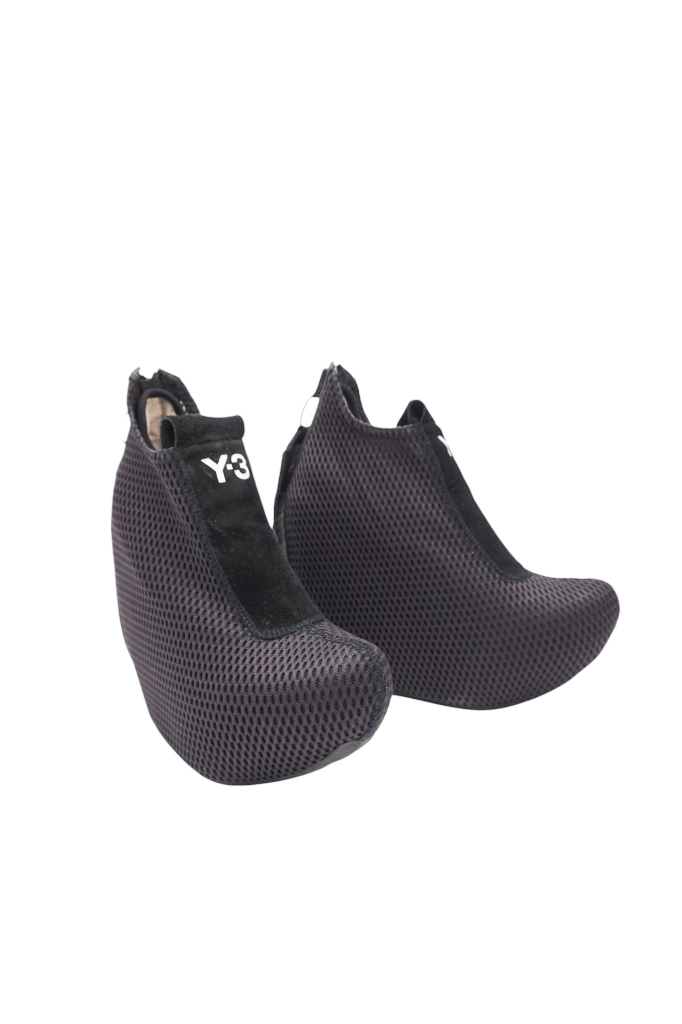 Pair of black textured high-heeled shoes on a white background